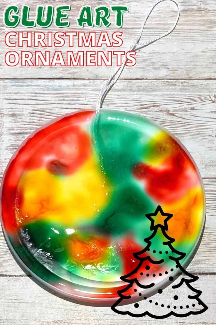 a glass ornament with a christmas tree on it and the text glue art christmas ornaments