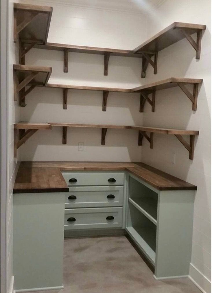 an empty walk in closet with shelves and drawers