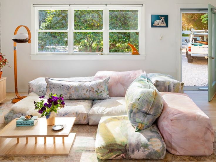 a living room filled with furniture and a large window