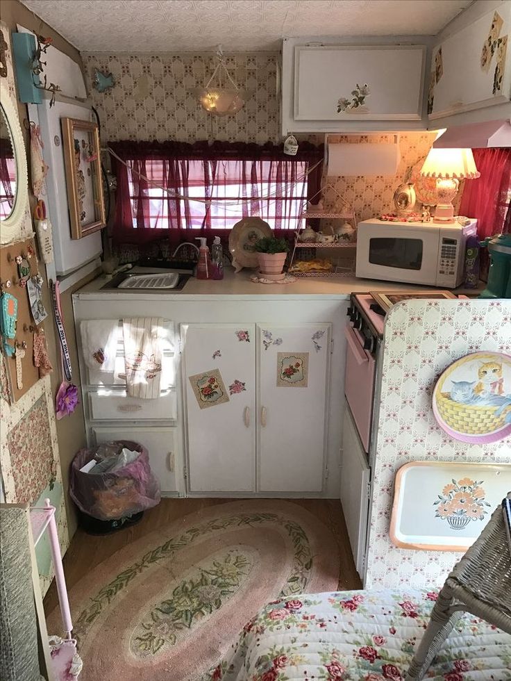 an old fashioned kitchen with lots of clutter