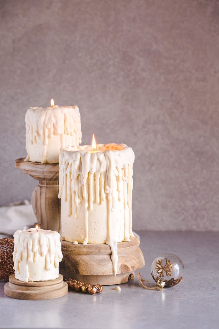 three candles sitting on top of a wooden stand