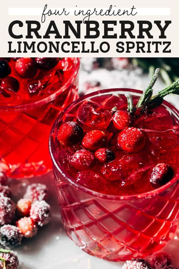 two glasses filled with cranberry limocello spritz on top of a table