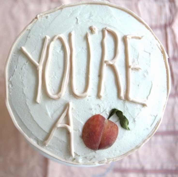 a white cake with the words you're a peach on it and an apple