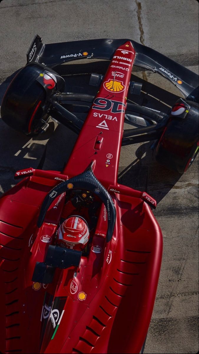 a red race car sitting on top of a track