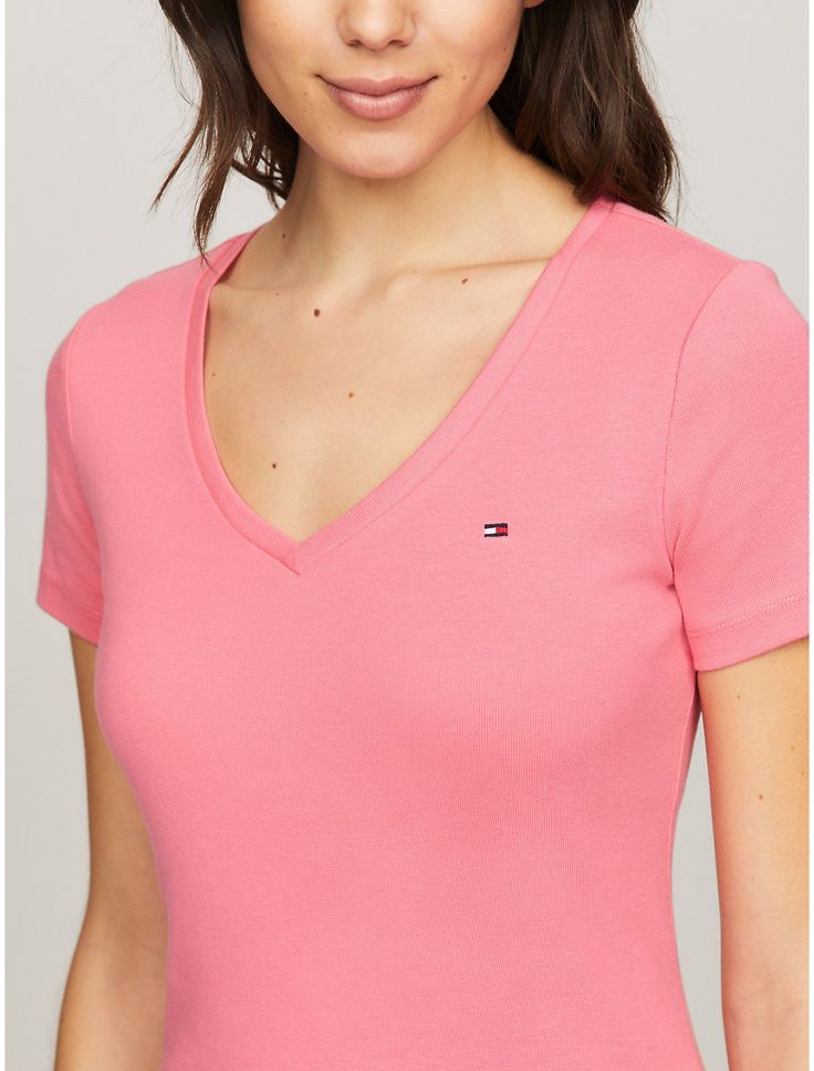 Tommy Hilfiger women's T-shirt. Made from soft, medium weight cotton, our Favorite Tees are designed to fit your form. Another reason to love them? They layer just as easily under a blazer as they do a zip hoodie.  Material: 100% Regenerative Cotton. Classic V-neck T-shirt For Spring, Trendy Tommy Hilfiger Cotton T-shirt, Classic Pink T-shirt For Summer, Tommy Hilfiger Classic Summer Tops, Spring Stretch Top By Tommy Hilfiger, Tommy Hilfiger Crew Neck Tops For Spring, Tommy Hilfiger Spring Crew Neck Tops, Tommy Hilfiger Stretch Tops For Summer, Tommy Hilfiger Stretch Top For Spring