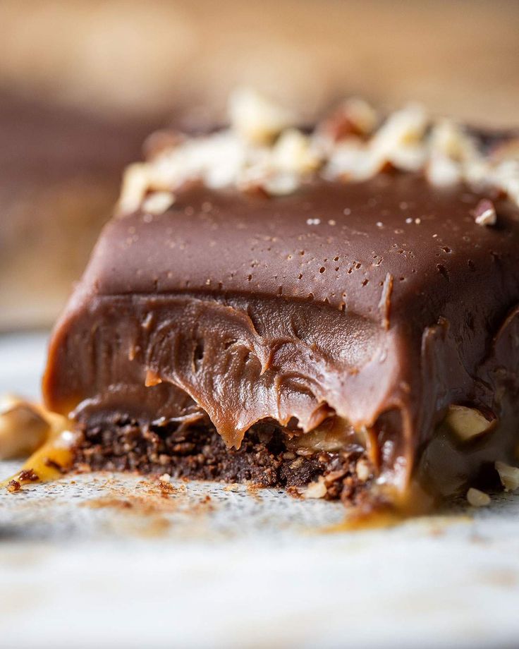 a piece of chocolate cake with nuts on top