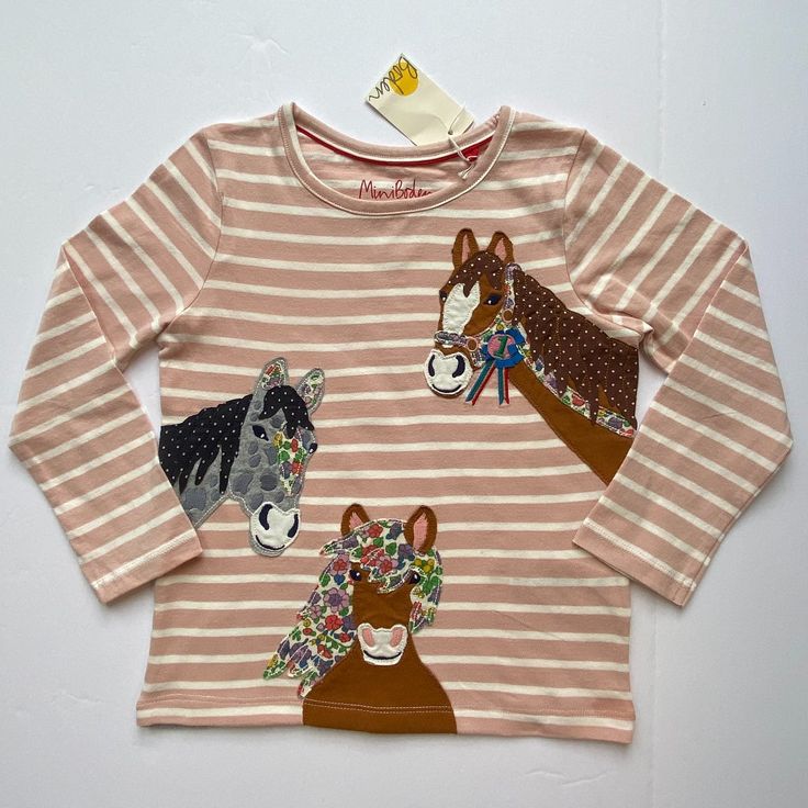 Nwt Mini Boden -- Your Little Horse Lover Will Want To Wear This Sweet Horse-Themed Pink Striped T-Shirt Every Day Of The Week! Three Friendly Horses Are Appliqued And Embroidered On The Front, And One More Is Hiding On The Back! Can Be Paired With A Twirly Corduroy Skirt And Floral, Pin Dot, Or Striped Leggings, Or Solid Corduroy Pants, Jeans, Or Even Under A Jumper. Remember That Mini Boden's Signature "Hotchpotch" Style Lets Her Wear Any Patterns Together So Long As There's A Shared Colorway. Playful Pink Cartoon Print Top, Pink Cartoon Print Crew Neck Top, Pink Crew Neck Top With Cartoon Print, Playful Pink Crew Neck Top, Pink Fun Crew Neck Top, Fun Pink Crew Neck Top, Fun Pink Shirt With Cartoon Print, Cute Pink Shirt For Fall, Cute Pink Fall Shirt