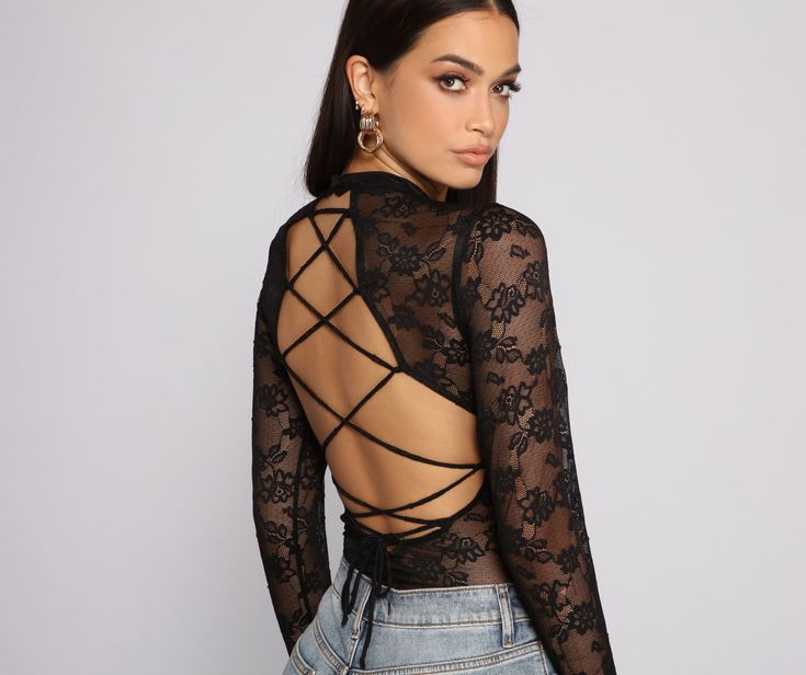 Lace-up in this sultry bodysuit that brings major lace appeal. The bodysuit features a lace bodice. long sleeves. and a sexy strappy back design. Complete your look with a bralette and high waist jeans.Fit & Features High round neckline Long sleeves Sheer unlined Lace bodice Completely sheer. bralette pictured not included Dual snap closure Thong bottom Backless Lace Trim Bodysuit For Night Out, Backless Bodysuit With Lace Closure For Party, Backless Bodysuit With Lace Trim For Party, Party Backless Bodysuit With Lace Closure, Party Backless Bodysuit With Lace Trim, Backless Party Bodysuit With Lace Trim, Party Lace Trim Backless Bodysuit, Edgy Long Sleeve Bodysuit For Night Out, Backless Lace Back Intimate For Party