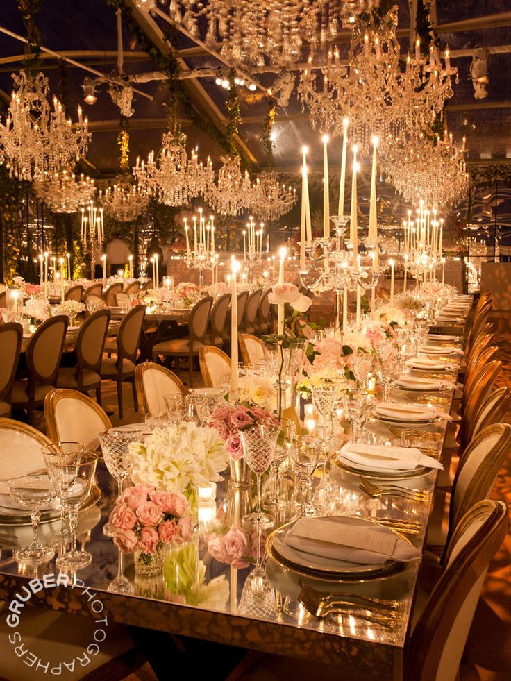 a long table is set up with candles and flowers for an elegant dinner or party