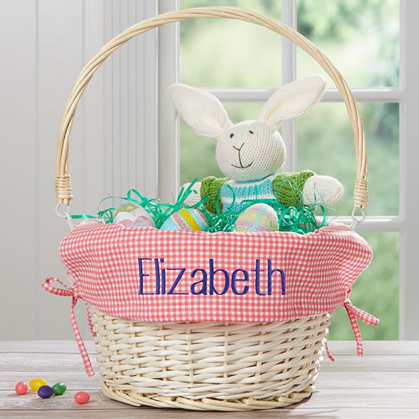 a basket with an easter bunny sitting in it and the name elizabeth written on it