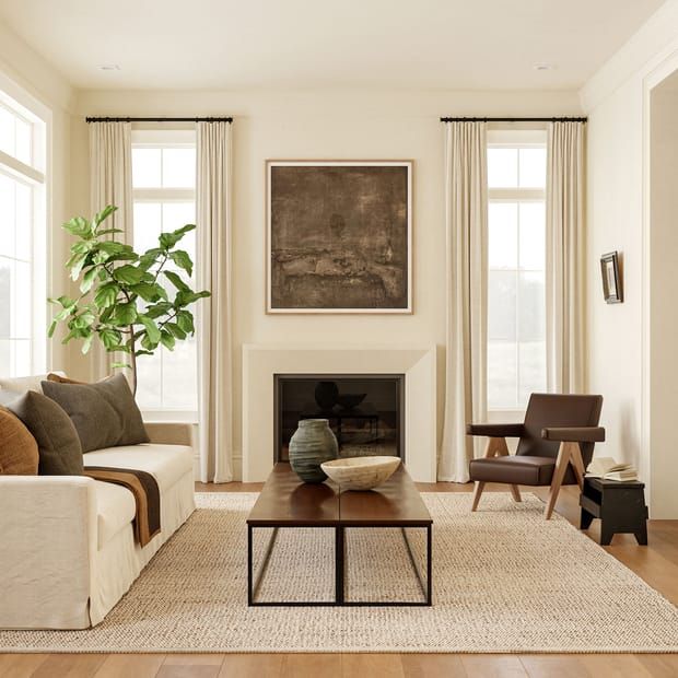 a living room with two couches and a coffee table in front of a fireplace