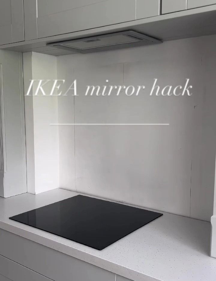 an empty kitchen with white cabinets and black counter tops that says ikea mirror hack