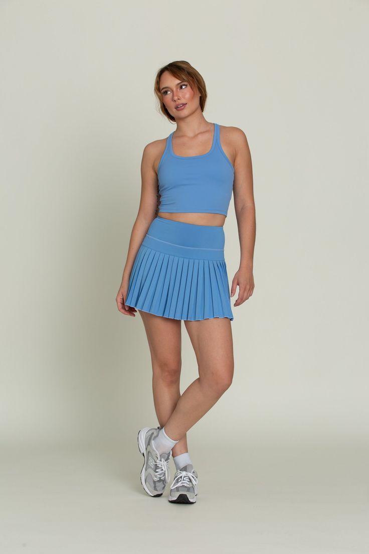 Our Marina Blue Racerback Crop Tank features a slight cropped fit and racerback style that is the perfect go-to athletic top. It is complete with sweat-wicking material and a double layer, built-in-removable padded bra. Casual Training Crop Top With Built-in Bra, Casual Compressive Racerback Sports Bra, Sporty Blue 4-way Stretch Sports Bra, Casual Compressive Blue Sports Bra, Blue 4-way Stretch Top With Seamless Construction, Blue Seamless Racerback Top, Blue Tops With Seamless Construction And 4-way Stretch, Blue Athleisure Tank Top For Running, Blue Cropped Sports Bra For Summer