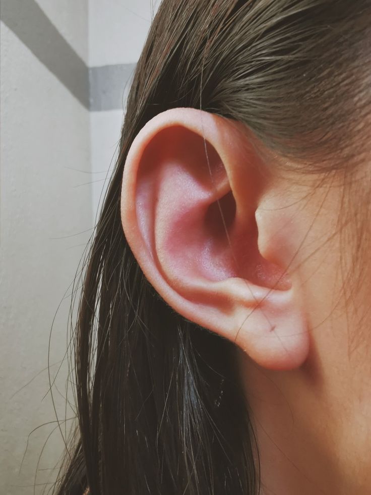 a woman's ear is shown from the side