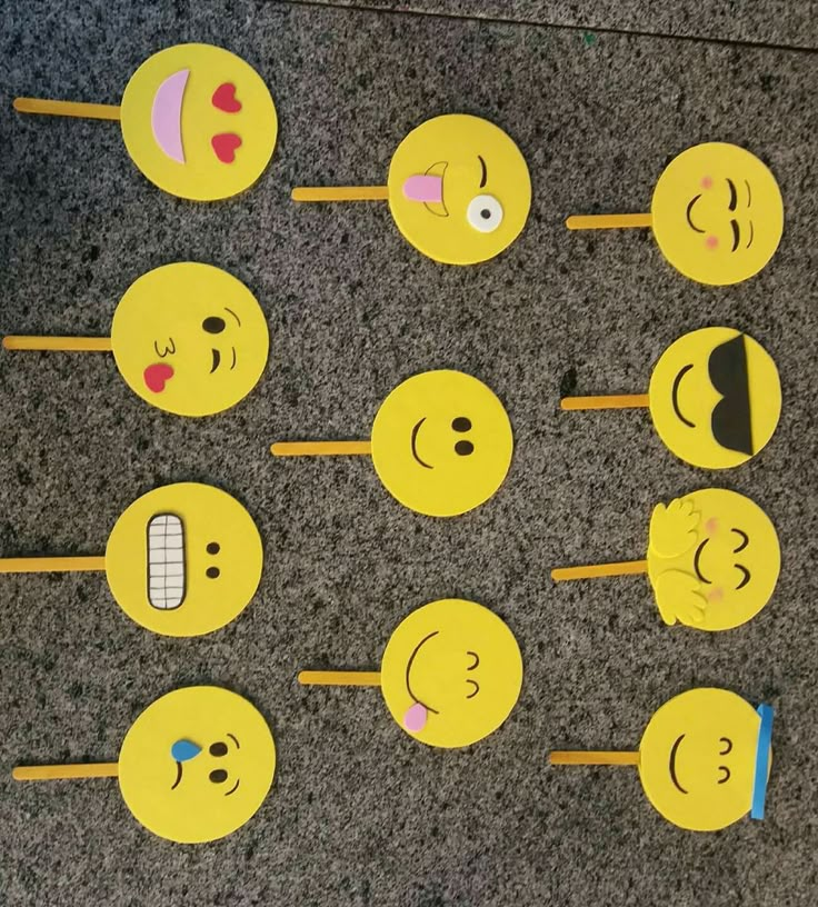 there are many smiley faces on the sticks