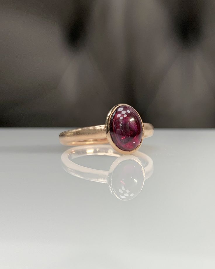 Natural Rhodolite Garnet Ring * Dainty Cabachon Ring * Genuine Garnet & 14K Solid Gold * Best Gift for Her/Him * Handmade Ring ◎ Details ◎ ○ Gemstone Details .Natural RHODOLITE GARNET Oval Cut 9X7 mm approx. 2.11 ct ○ Gold Details 14K Solid Gold Width of Band : 2.50 mm Weight of Ring : approx 3.80 gr Made to Order HANDMADE ITEM ○ Upgrade to Solid 18K Gold, please click the link below: https://www.etsy.com/listing/962826004 For more CABACHON BEZEL rings : http://etsy.me/37fvI60 All of our jew Elegant Domed Jewelry With Bezel Setting, Classic 14k Gold Sapphire Oval Cabochon Ring, Luxury 14k Gold Oval Cabochon Rings, Luxury Yellow Gold Rings With Garnet, Luxury Yellow Gold Ruby Ring With Bezel Setting, Elegant Garnet Ring With Bezel Setting, Luxury 14k Gold Ruby Cabochon Ring, Formal Oval Cabochon Ruby Ring With Bezel Setting, Elegant Domed Sapphire Ring In Yellow Gold