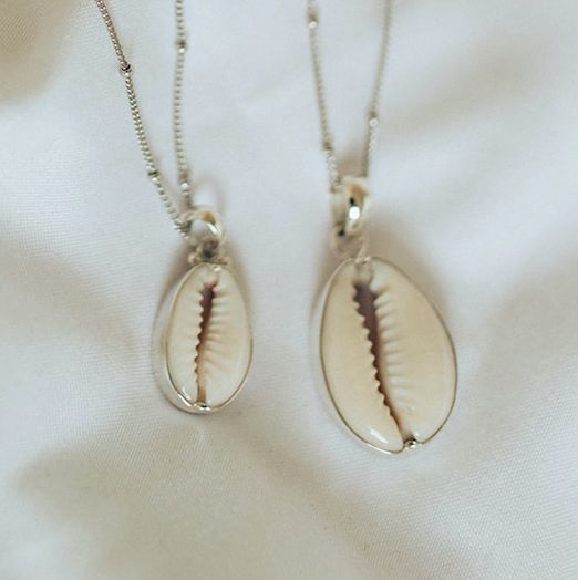 Pick which size shell you like best! Cowrie Shell White Gold-Plated 100% Sterling Silver Base Nickel free Hypoallergenic Pearl Clasp 18" Chain 2" Extender Tarnish Resistant Please note: Each shell may vary slightly. Silver Shell Jewellery, Cowrie Shell Necklace, Larimar Necklace, Pearl Clasp, Wave Necklace, Stamped Rings, Shell Ring, Crescent Moon Necklace, Shell Necklace