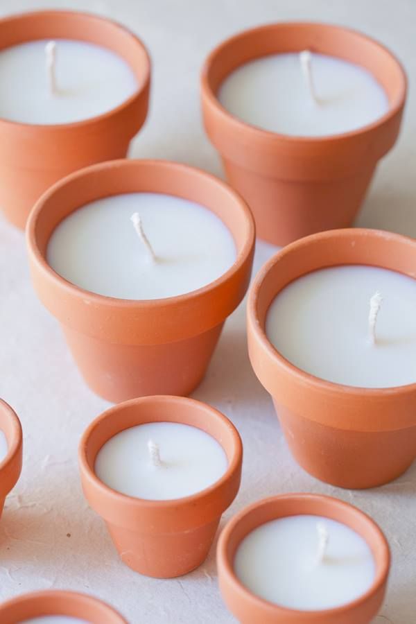 several small clay pots with candles in them