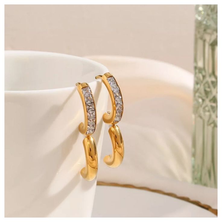 These gorgeous 14K Gold Huggie Hoop Earrings are 20mm, 14K gold plated with stainless steel and high quality cubic zirconia. The 14K Gold Huggie Hoop Earrings make the perfect gift for birthdays, Christmas Gifts, formal attire, business or casual. These earrings are also tarnish free, water proof and hypoallergenic. Order your 14K Gold Huggie Hoop Earrings now with our FREE & fast same day shipping! Plated Hoop Drop Earrings For Anniversary, Trendy Yellow Gold Hoop Earrings For Anniversary, Gold Hoop Earrings With Diamond Accents As Gift, Cubic Zirconia Hoop Earrings As Gift, Modern Gold Cubic Zirconia Huggie Earrings, Gold Cubic Zirconia Hoop Earrings For Everyday, Modern Gold Huggie Earrings With Cubic Zirconia, Everyday Gold Hoop Earrings With Cubic Zirconia, Trendy Tarnish Resistant Hoop Earrings For Anniversary