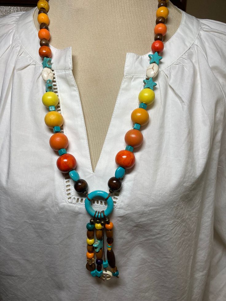 A single strand with pendant.  Another necklace that remind me of Aztec  culture.  A fun and multi colored necklace. Unique Multicolor Beaded Necklaces For Beach, Unique Multicolor Necklaces For The Beach, Casual Multicolor Jewelry For Festival, Casual Multicolor Festival Jewelry, Multicolor Wooden Beads Long Necklace Gift, Multicolor Spiritual Long Beaded Necklaces, Multicolor Spiritual Long Beaded Necklace, Multicolor Pendant Necklace For The Beach, Unique Adjustable Multicolor Long Necklace