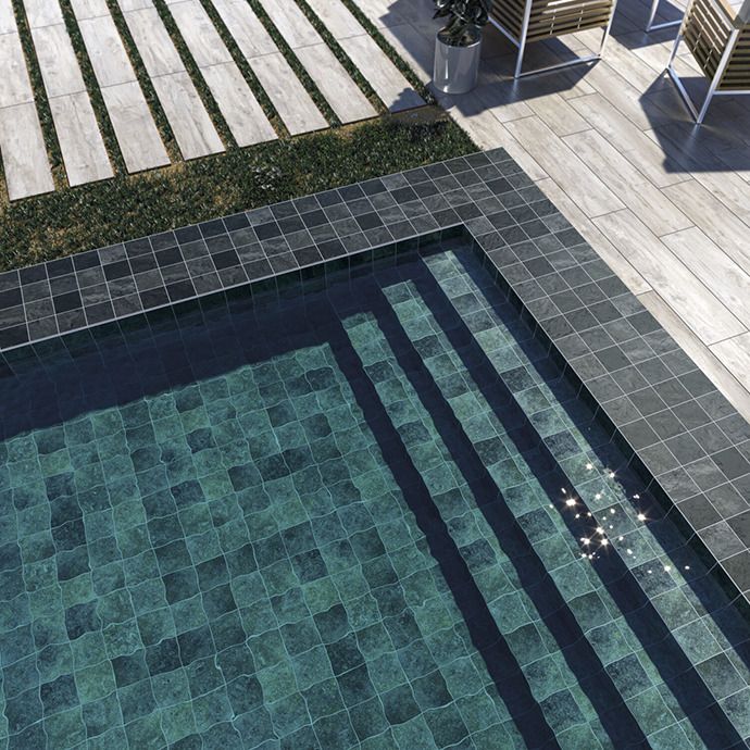 an aerial view of a swimming pool with chairs