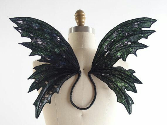 a white mannequin with black wings on it