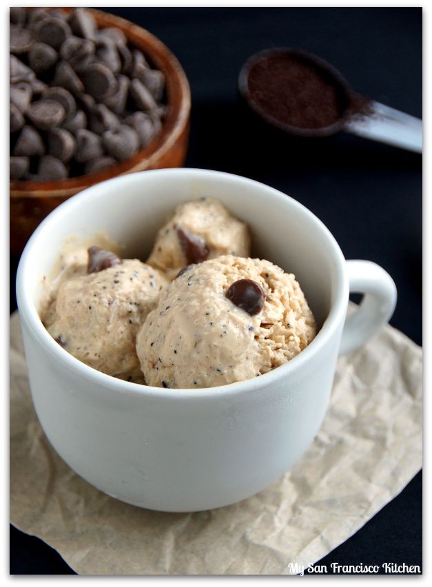 a bowl filled with cookies and chocolate chips next to a bowl of ice cream on top of a napkin