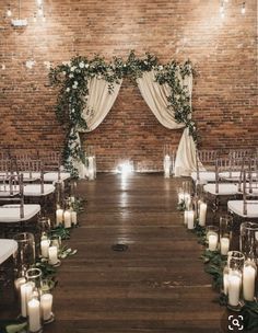 an indoor ceremony with candles and greenery