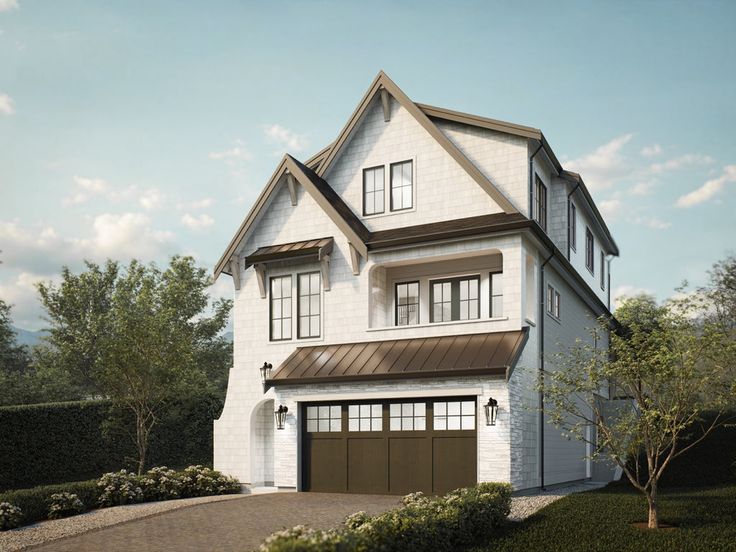 a two story white house with brown garage doors