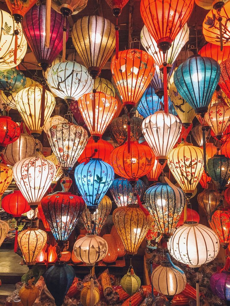 many colorful lanterns are hanging in the air