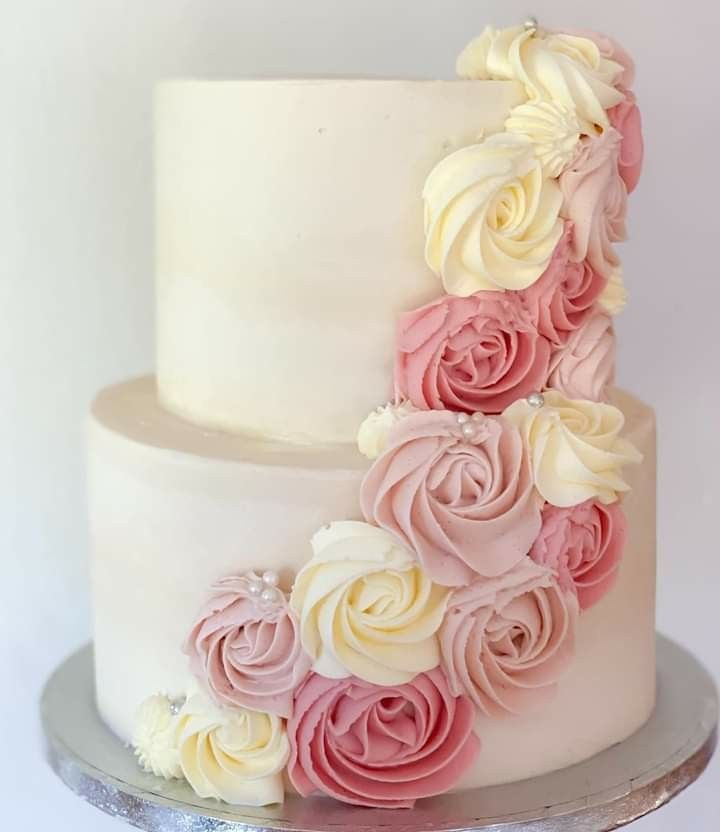 a white and pink cake with flowers on it