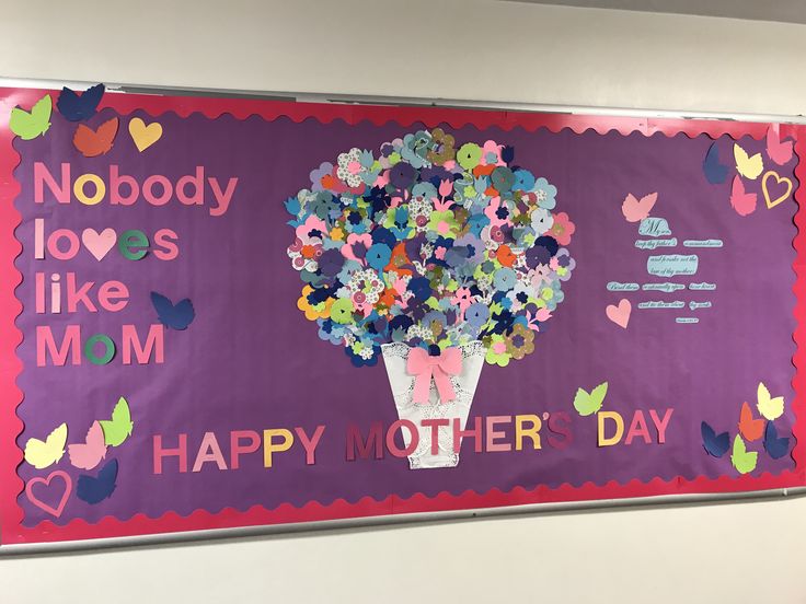 a mother's day bulletin board with flowers in a vase and butterflies on it