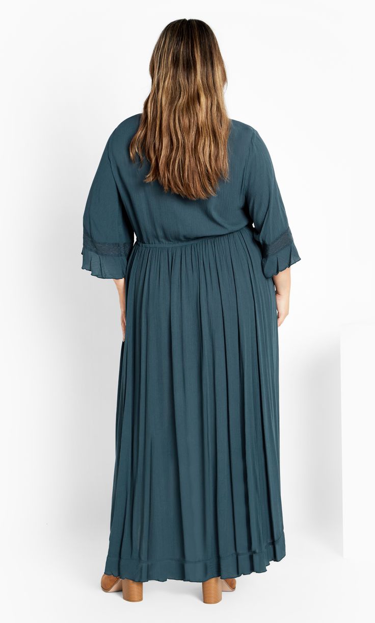 Drape your curves in the flowy Cadence Dress, offering a beautifully bohemian aesthetic. This dress can be styled up or down depending on the occasion, with sleeved coverage and a dreamy maxi hemline. Key Features Include: - V-neckline - Decorative buttons on bodice - Elbow length bell sleeves - Drawstring waist - Ruffle detailing on skirt - Lace embellishments - Relaxed silhouette - Unlined Keep it cool and casual in a tassel handbag and heeled boots. | Plus Size Cadence Aegan Dress in Aegean, Bohemian V-neck Dress With Flowy Skirt, Breezy Boho V-neck Flowy Dress, Modest Flowy Rayon Maxi Dress, Chic Flowy Rayon Boho Dress, Modest Flowy Rayon Dress, Flowy Breezy Boho Maxi Dress, Elegant Flowy Long Boho Dress, Bohemian Dress With Flowy Midi Skirt, Elegant Long Flowy Boho Dress