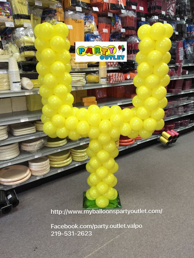 a balloon shaped like the letter h in a store