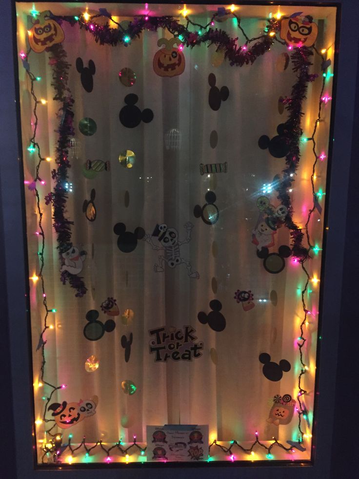 a mickey mouse window decorated with lights and decorations