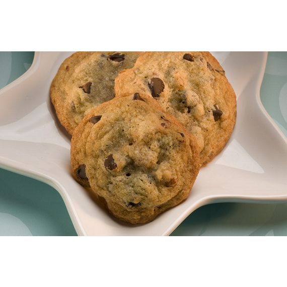 three chocolate chip cookies on a white serving dish with blue background and watermarked