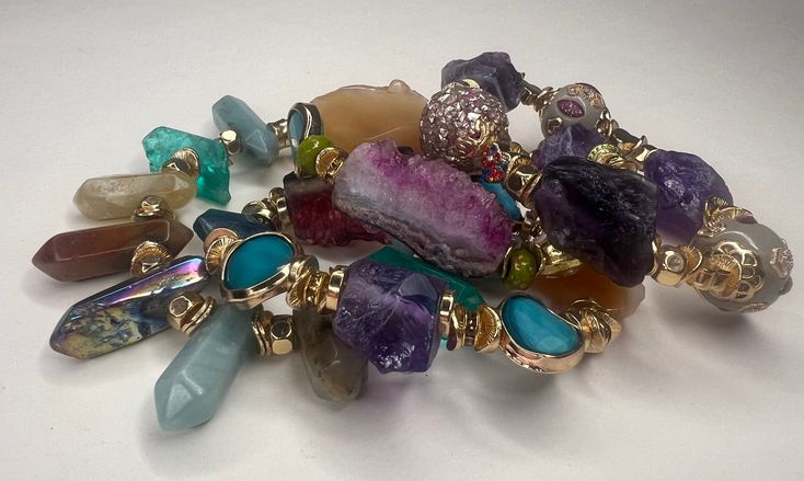 We'd love to introduce you to this Beautifully curated design of 4 Semi Precious Stone Mix bracelets. When we handcrafted this design, it became more than just a regular release of accessories. This design consists of years of collecting and finally piecing together. Ranging from an array of Amethyst, Agate and Amazonite, these precious stones are rare and are meant for only ONE person. If you resonate with these pieces, this is definitely for you. * Handmade Item * One of a Kind * Consists of 4 Unique Multicolor Gemstone Bracelets, Luxury Handmade Party Bracelets, Luxury Handmade Party Bracelet, Multicolor Hand Wrapped Bracelets For Party, Adjustable Fusion Bracelets For Party, Multicolor Fusion Style Bracelets For Party, Adjustable Fusion Style Bracelets For Party, Fusion Style Bracelet With Unique Variations As A Gift, Unique Multicolor Stackable Jewelry