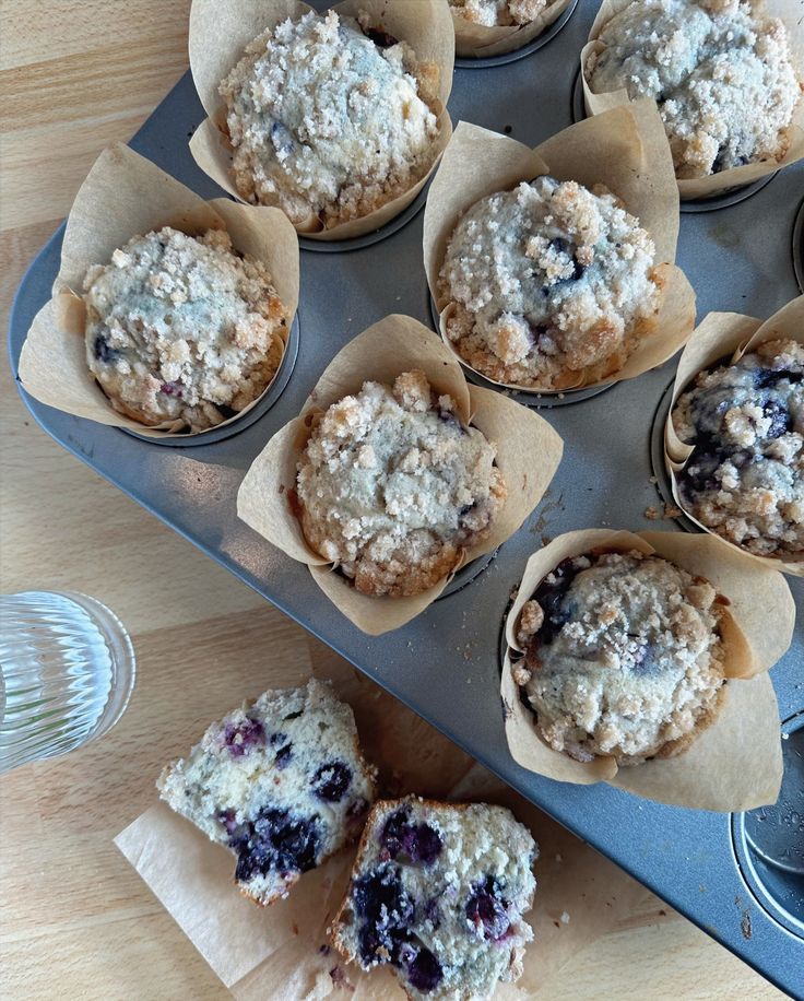 muffins with blueberries are sitting on a baking tray and ready to be baked