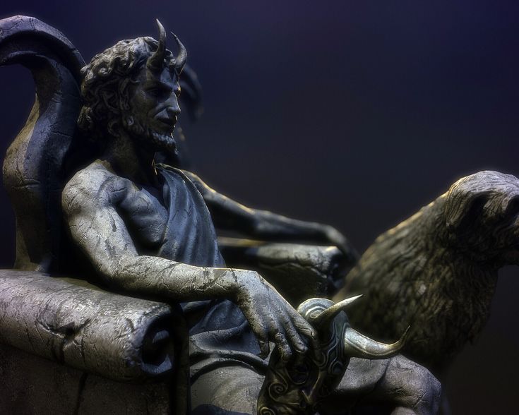 a statue of a man sitting on top of a goat