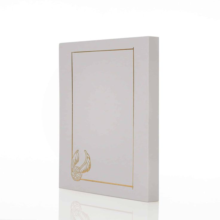 a white box with gold foil on the front and bottom, sitting against a white background