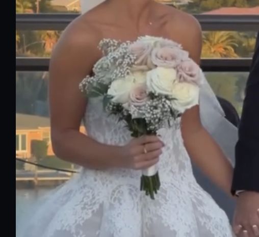 the bride and groom are holding hands