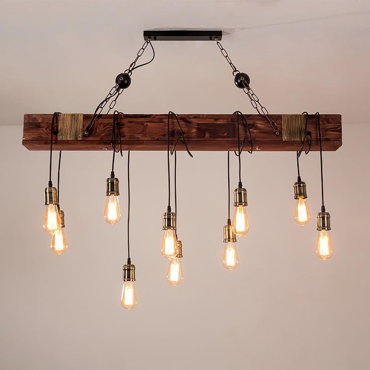 a wooden beam with six light bulbs hanging from it's center and four lights on each end