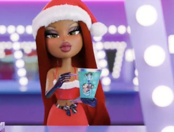 the doll is wearing a santa hat and holding a cup