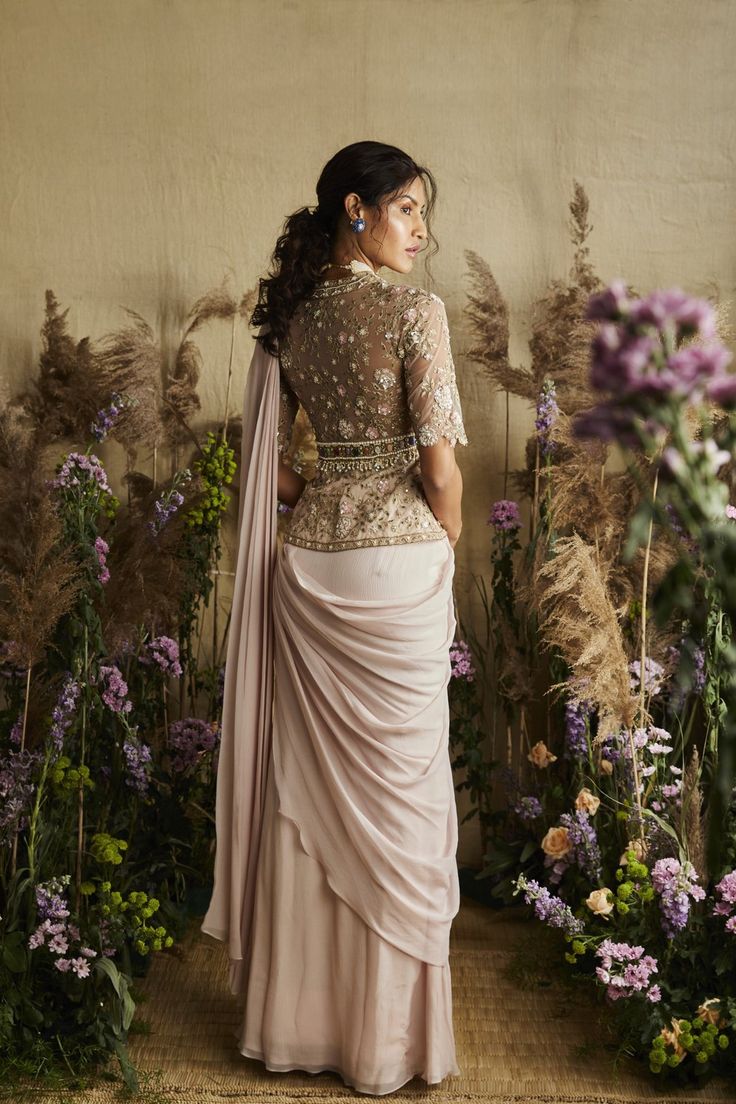 This set features a pale pink stitched sari with multicolor embroidery and feather on blouse design with hand and machine embroidery. Neck: Round Sleeve Type: Feather Sleeves Fabric: Chiffon; Net Lining Fabric: Shantoon Closure: Back zip Evening Anarkali Blouse With Sheer Dupatta, Traditional Fitted Pre-draped Saree With Pearl Embroidery, Evening Anarkali Blouse With Traditional Drape, Pink Embellished Blouse With Traditional Drape, Designer Pearl Embroidery Fitted Saree, Pre-draped Pearl Embroidered Saree For Diwali, Pink Embellished Blouse Piece For Evening, Embellished Pink Silk Pre-draped Saree, Pink Embellished Silk Pre-draped Saree