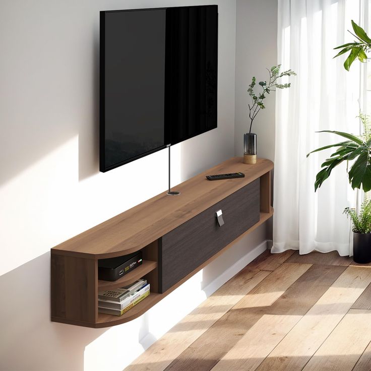 a flat screen tv mounted to the side of a wooden entertainment center in a living room