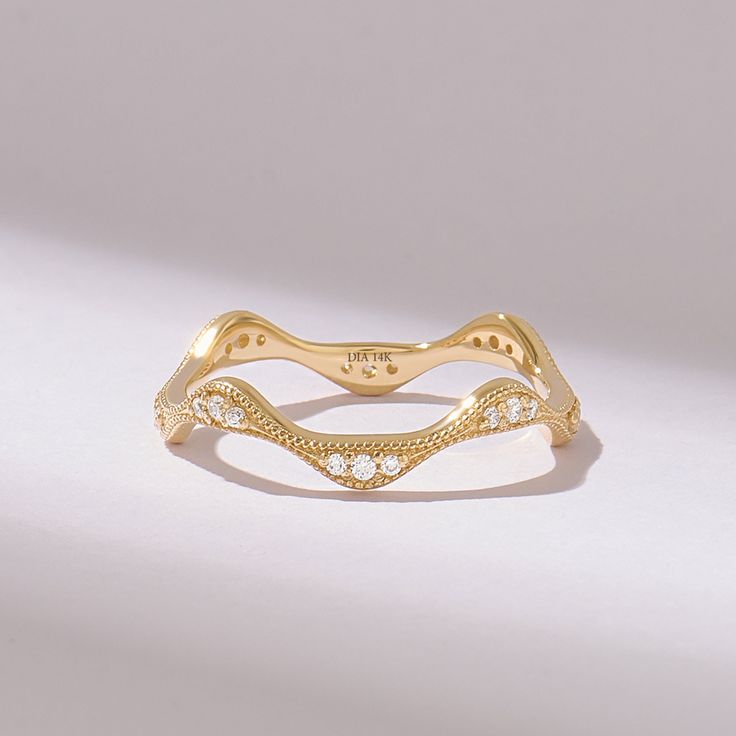 a gold ring with white diamonds on it