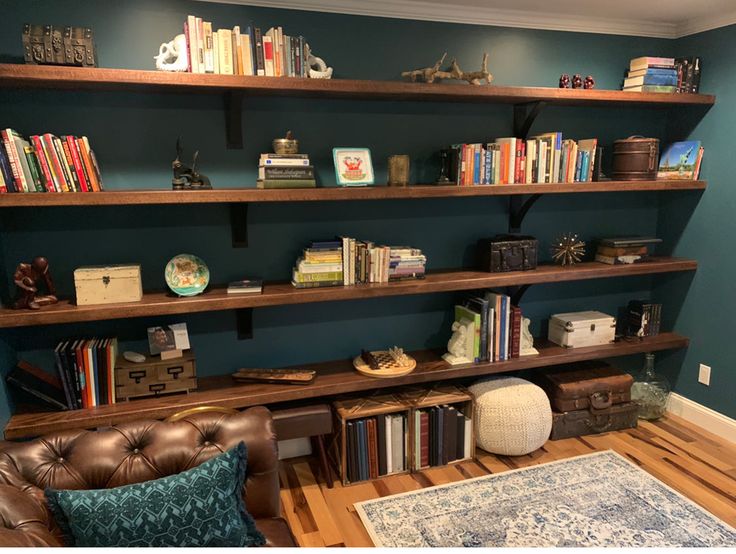 a living room filled with furniture and lots of bookshelves on top of it