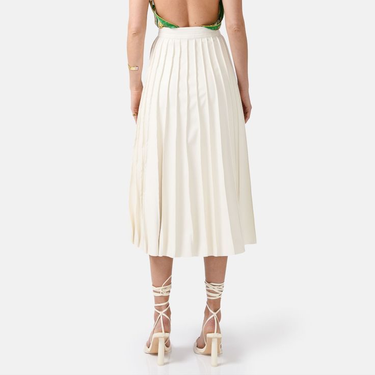 Step into effortless elegance with the Solace Vegan Leather Pleated Midi Skirt in white. With a hidden zip closure and stylish golden embellishments, this skirt combines sophistication with a touch of luxury. The lightweight fabric drapes beautifully, offering a relaxed yet structured fit with just the right amount of stretch for comfort and durability. The vertical hand-pleating creates a flattering silhouette by elongating the lower body. Perfect for stylish occasions where comfort is key, thi White Formal Midi Bottoms, White Pleated Skirt For Party, Luxury Lined Midi Skirt, Luxury White Skirt For Spring, White Midi-length Bottoms For Evening, White Midi Length Bottoms For Evening, White Midi Length Formal Skirt, Elegant Summer Pleated Pencil Skirt, White Formal Midi Skirt