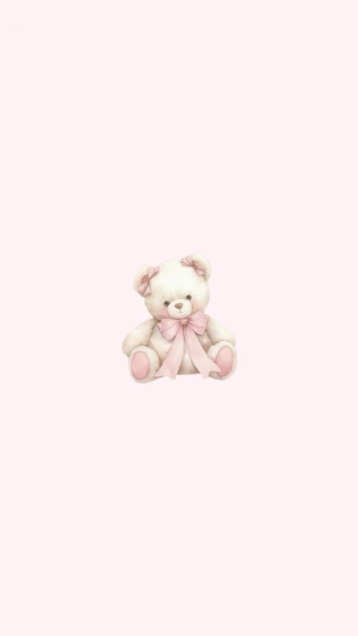 a white teddy bear sitting on top of a pink wall