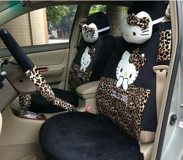 two hello kitty car seat covers in the back of a car with leopard print on them